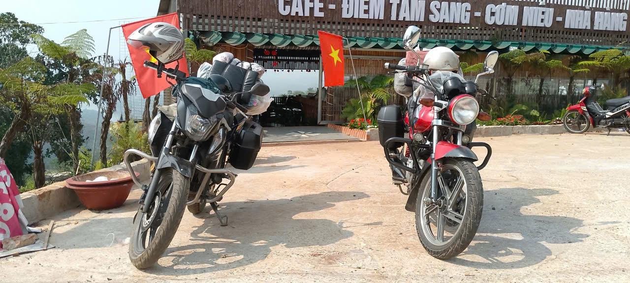 Two Easy Rider touring motorbikes loaded with luggage at a roadside cafe in the Central Highlands